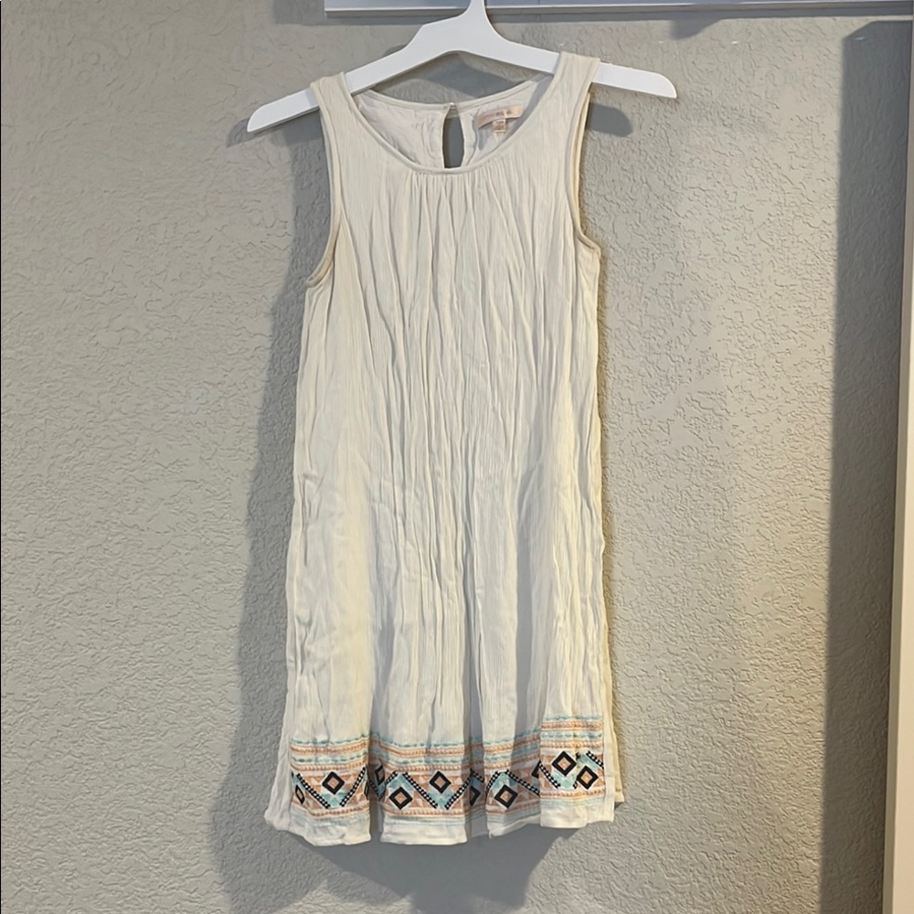 Sleeveless White Dress with Embroidered Hem